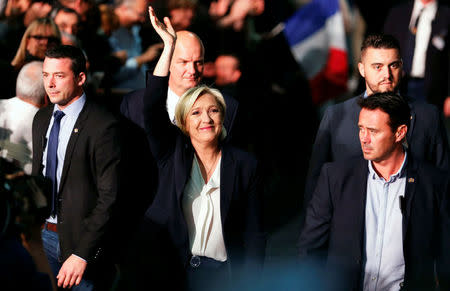 Marine Le Pen, French National Front (FN) political party leader and candidate for French 2017 presidential election, waves to supporters as she arrives surrounded by security members at a political rally in Bordeaux, France, April 2, 2017. REUTERS/Regis Duvignau