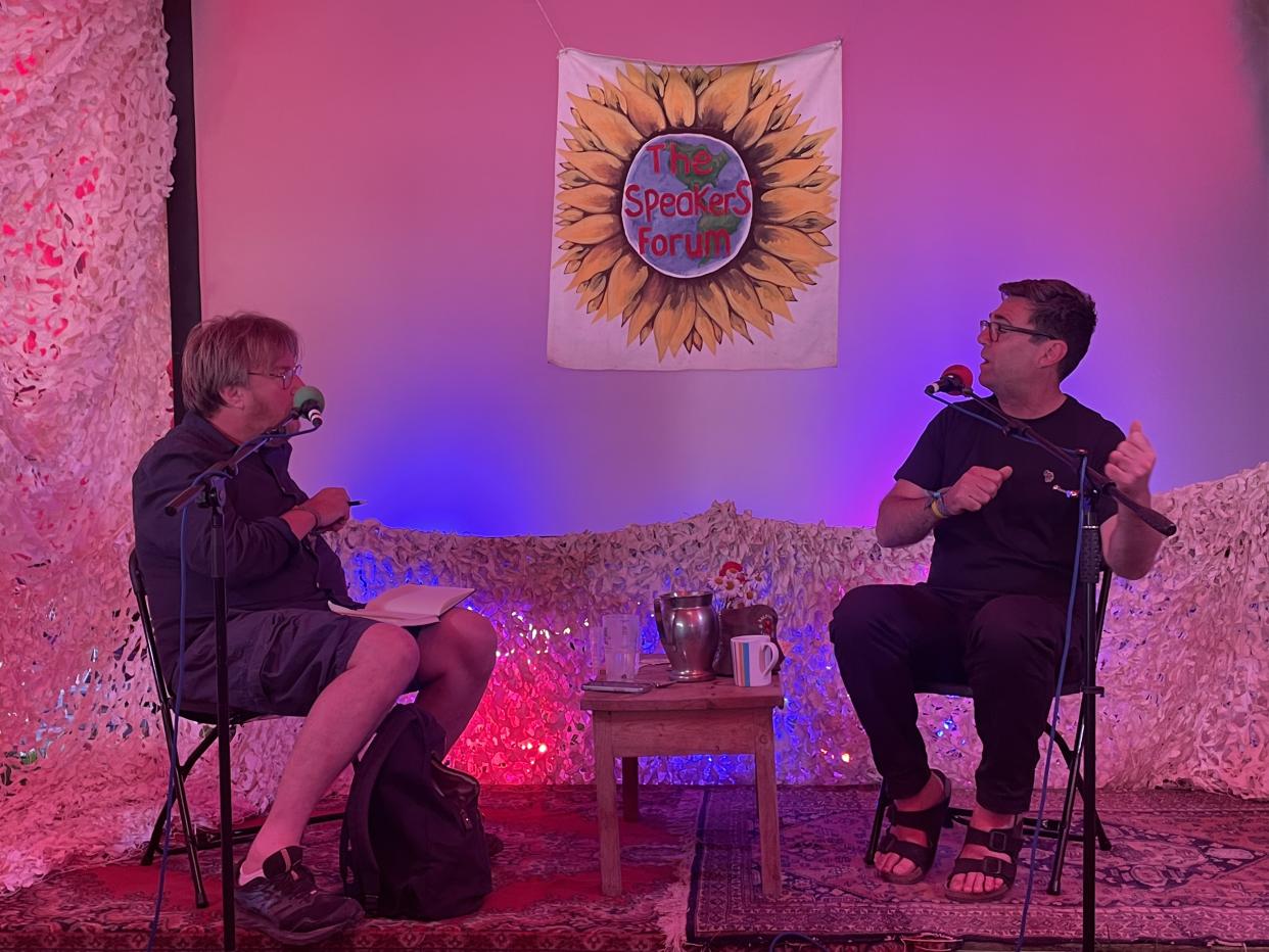 Mr Burnham (right) speaking to journalist John Harris (left) at Glastonbury Festival