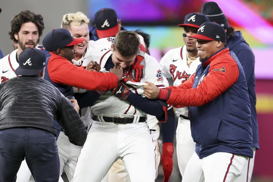 The Atlanta Braves celebrate a walk-off single by Austin Riley to end game one.