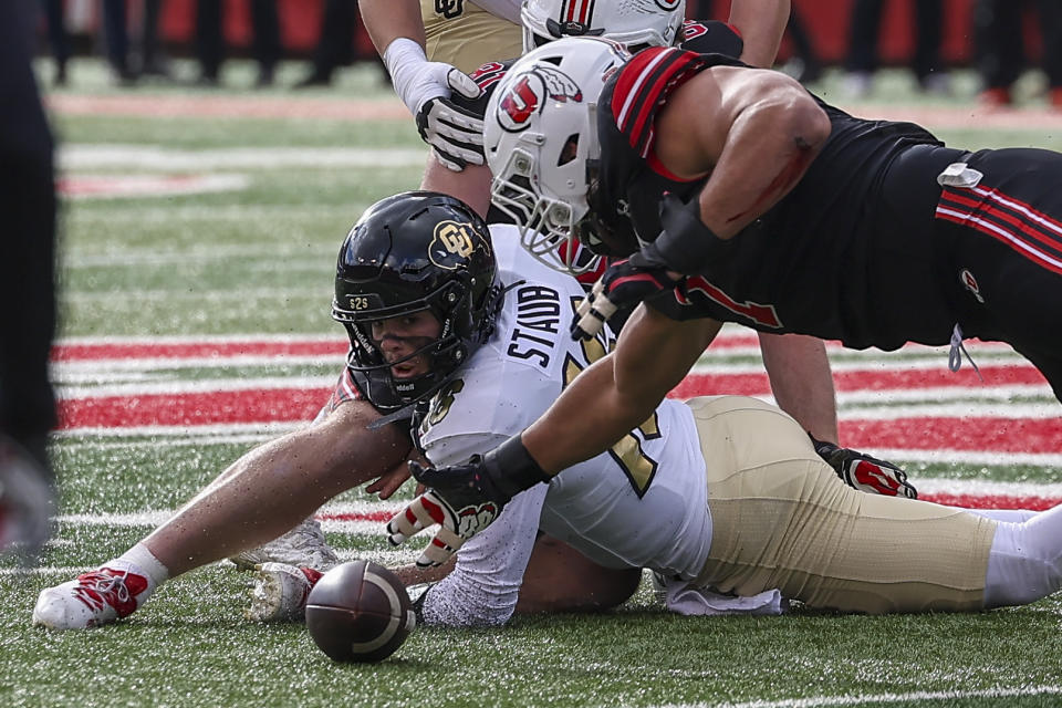 Colorado quarterback Ryan Staub has the ball knocked away and recovered by Utah defensive end Van Fillinger (7) during the first quarter of an NCAA college football game Saturday, Nov. 25, 2023, in Salt Lake City. (AP Photo/Rob Gray)