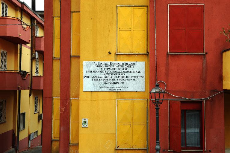 A plaque on the city hall's facade pays homage to a former mayor, Domenico Dimaio: "the pride of the honest residents of Plati, victim of his duty, assassinated in barbaric fashion at the hands of criminals"