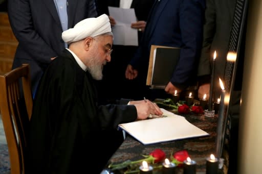 Iranian President Hassan Rouhani signs a book of condolences for passengers on a Ukrainian airliner shot down in a catastrophic error