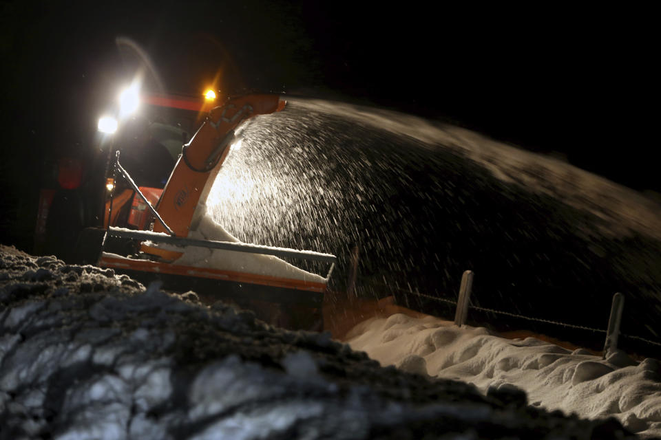 A snowplow removes snow from a road in Obermailselstein, Germany, Tuesday, Jan. 15, 2019. (Josef Hildenbrand/dpa via AP)