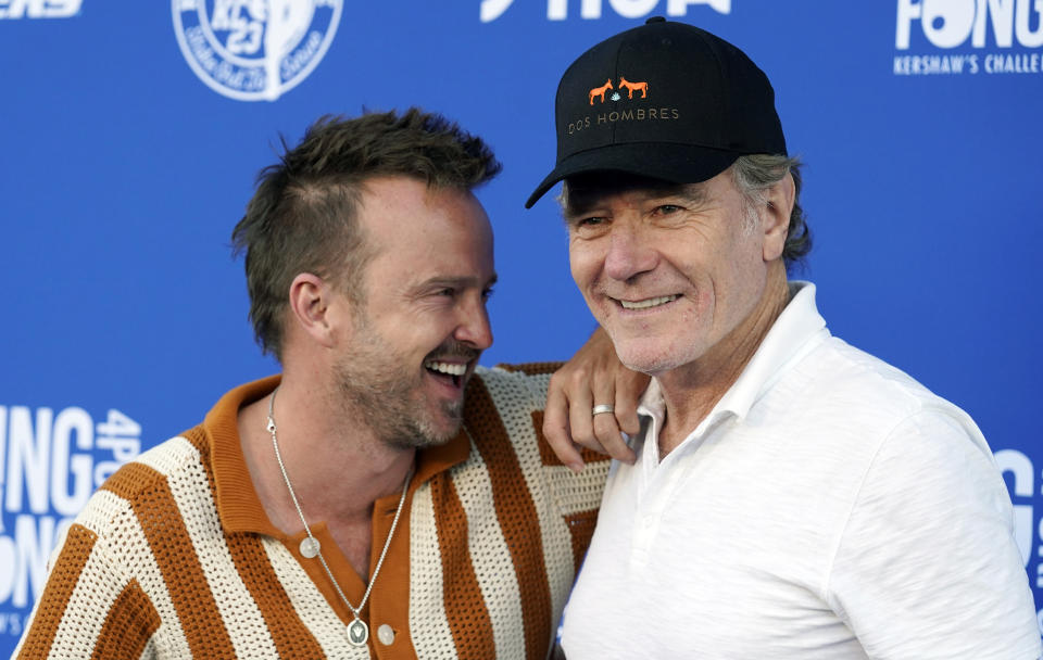 Actors Aaron Paul, left, and Bryan Cranston, who were cast members in the television series "Breaking Bad," pose together at the 10th Annual PingPong4Purpose celebrity ping pong tournament hosted by Los Angeles Dodgers pitcher Clayton Kershaw and his wife, Ellen, Thursday, July 27, 2023, at Dodger Stadium in Los Angeles. (AP Photo/Chris Pizzello)