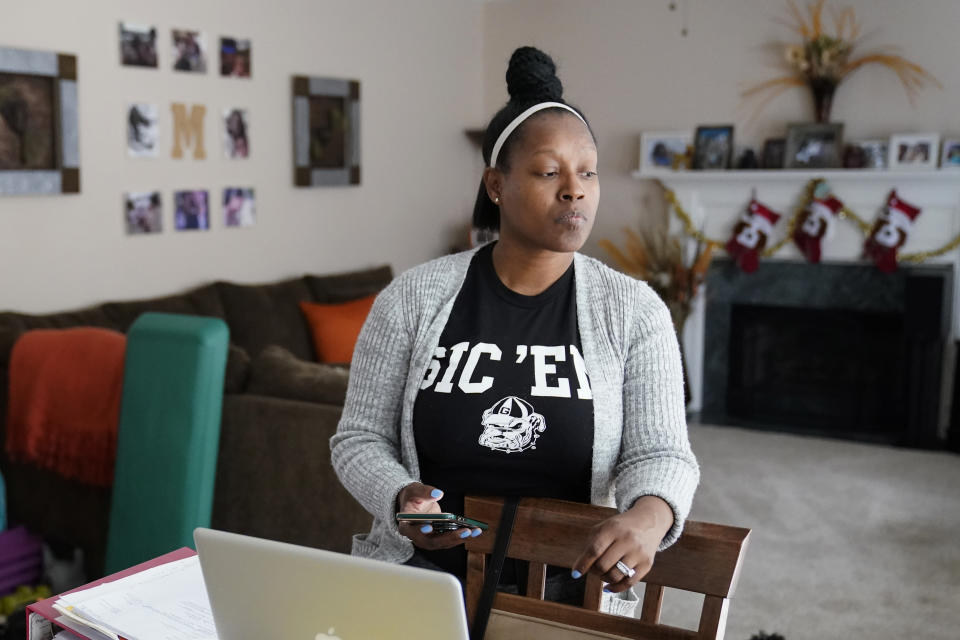 Shanita Matthews pauses as she speaks in her home, Wednesday, Dec. 23, 2020, in Suwanee, Ga. Matthews had to close her wedding business because of the coronavirus outbreak. (AP Photo/John Bazemore)