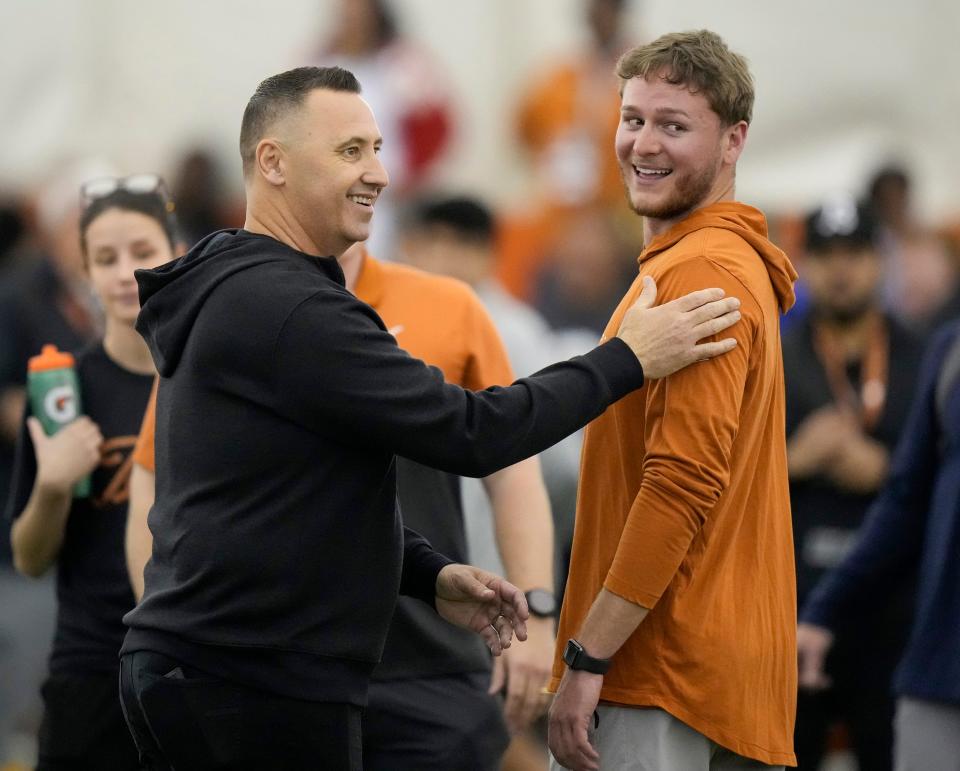 Texas coach Steve Sarkisian, left, greets quarterback Quinn Ewers at Texas Pro Timing Day in March. Sarkisian told reporters at SEC media days Wednesday that Ewers' emotional growth has been amazing. Ewers will lead the Horns into the 2024 opener against Colorado State.