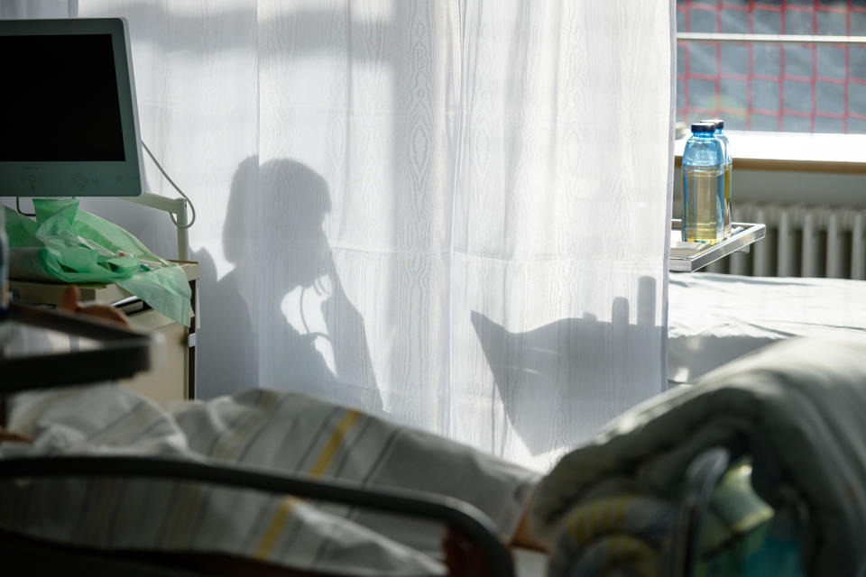 A silhouette of a patient being treated in a hospital.
