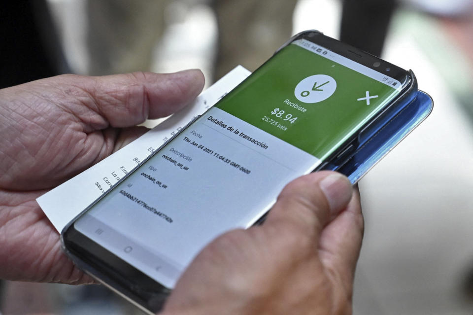 A man uses the Bitcoin app during the presentation of a Bitcoin ATM by Athena Bitcoin Inc. at a shopping mall in San Salvador, on June 24, 2021. - The Bitcoin is an official currency in El Salvador. (Photo by MARVIN RECINOS / AFP) (Photo by MARVIN RECINOS/AFP via Getty Images)