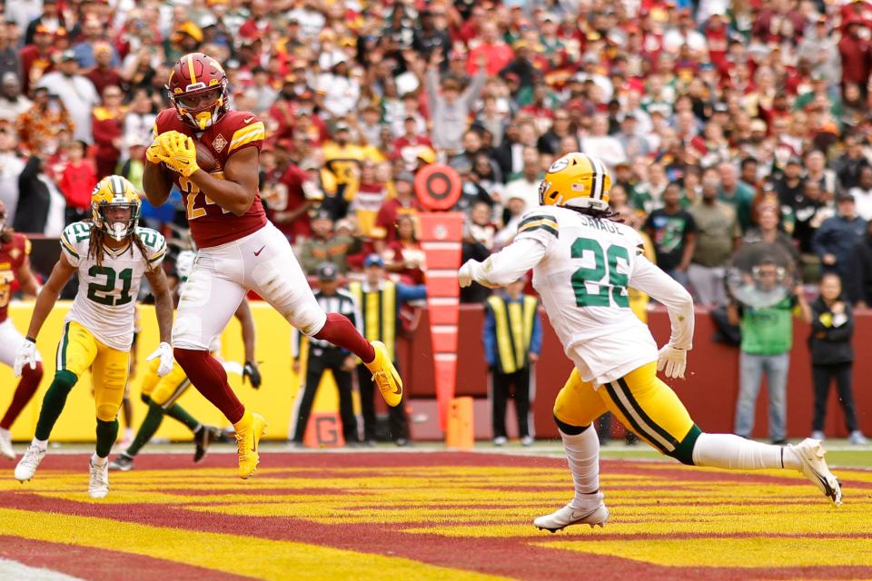 The Washington Commanders' Antonio Gibson catches a touchdown pass against the Green Bay Packers on Oct. 23.