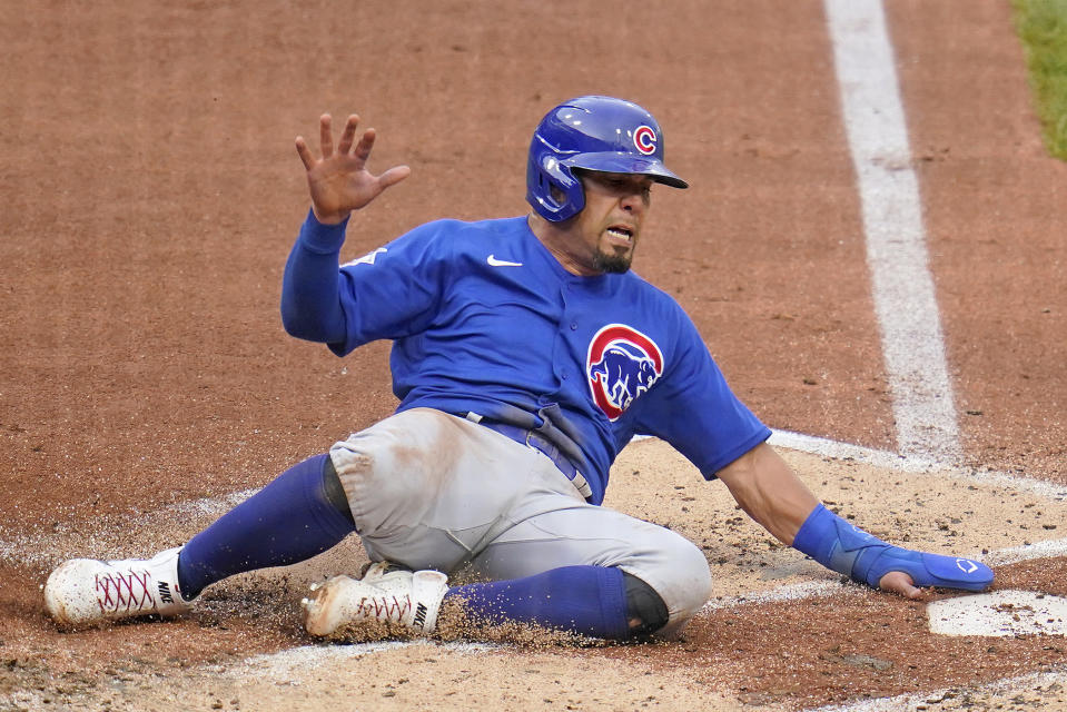 Chicago Cubs' Alfonso Rivas scores the second of two runs driven in on a single by Patrick Wisdom off Pittsburgh Pirates starting pitcher Jered Eickhoff during the second inning of a baseball game in Pittsburgh, Wednesday, June 22, 2022. (AP Photo/Gene J. Puskar)