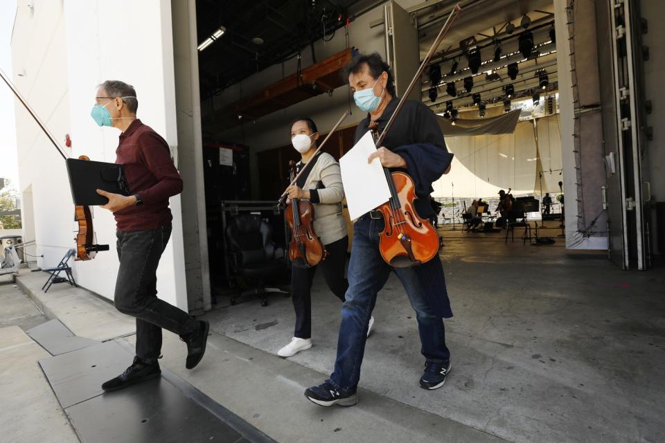 Musicians walk out of the backstage area