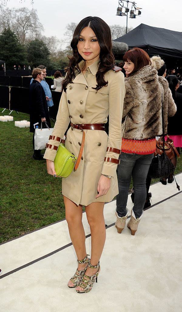 Gemma Chan wearing a trench coat dress