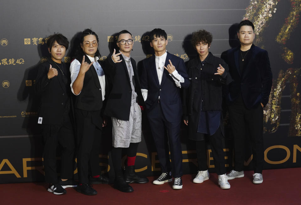 Taiwanese pop group ZenKwun pose as they arrive for the 31th Golden Melody Awards in Taipei, Taiwan, Saturday, Oct. 3, 2020. The awards show, one of the world's biggest Chinese-language pop music annual events was postponed from June to Oct. due to the coronavirus pandemic. (AP Photo/Billy Dai)