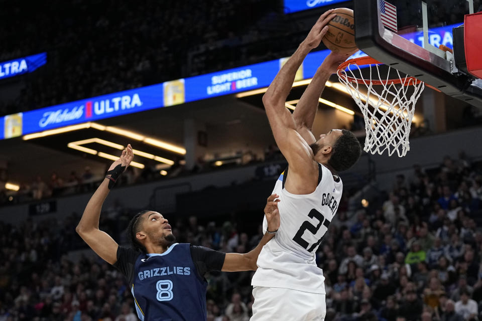 Minnesota Timberwolves center Rudy Gobert (27) dunks against Memphis Grizzlies forward Ziaire Williams (8) during the second half of an NBA basketball game, Friday, Jan. 27, 2023, in Minneapolis. (AP Photo/Abbie Parr)