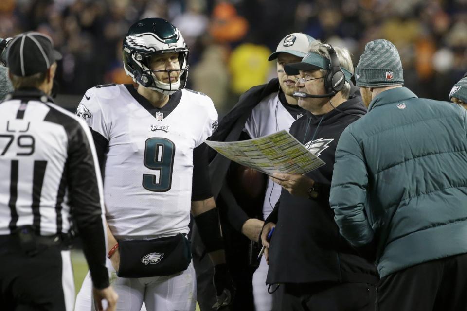 Philadelphia Eagles quarterback Nick Foles (9) talks to head coach Doug Pederson during the second half of an NFL wild-card playoff football game against the Chicago Bears Sunday, Jan. 6, 2019, in Chicago. (AP Photo/David Banks)