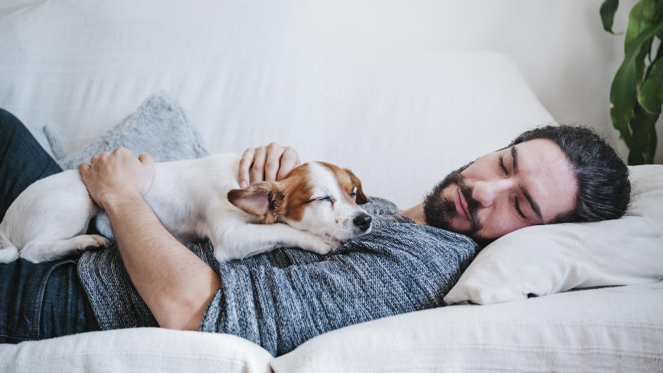 Man asleep with dog on chest
