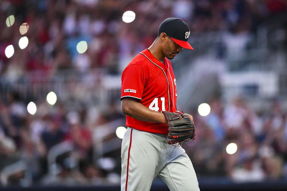 Washington Nationals' Joe Ross walks to the dugout under dimmed stadium lights while being relieved in the sixth inning of a baseball game against the Atlanta Braves, Sunday, July 21, 2019, in Atlanta. (AP Photo/John Amis)