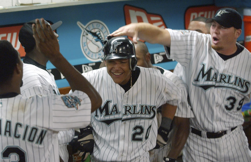 FILE - Florida Marlins' Miguel Cabrera, center, celebrates with teammates after connecting for the game winning two-run home run off Tampa Bay Devil Rays relief pitcher Al Levine in the 11th inning of a baseball game, June 20, 2003, in Miami. Cabrera, one of the greatest hitters of all time, is retiring after the Tigers wrap up their season Sunday, Oct. 1, 2023, and baseball’s last Triple Crown winner is leaving a lasting legacy in the game and his native Venezuela. (AP Photo/Alan Diaz, File)