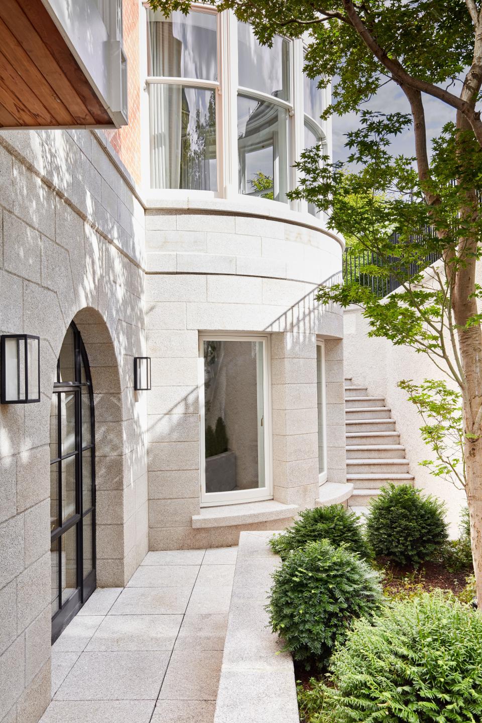 The outdoor basement-level area uses granite from McEvoy Stone and Japanese maple supplied by Bernard Hickie.