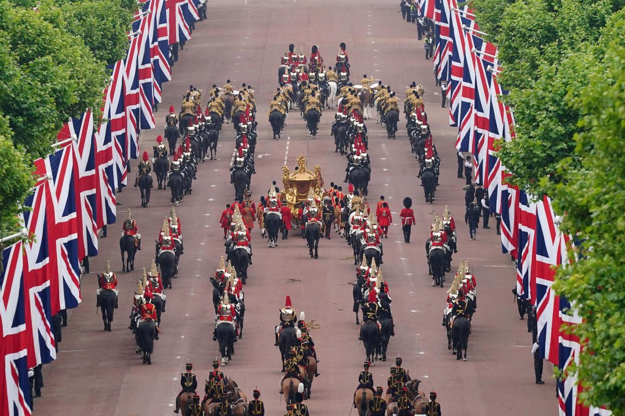 The Gold State Coach is seen on The Mall during the Platinum Jubilee Pageant outside Buckingham Palace in London on Sunday, June 5, 2022, on the last of four days of celebrations to mark the Platinum Jubilee. The pageant will be a carnival procession up The Mall featuring giant puppets and celebrities that will depict key moments from Queen Elizabeth II’s seven decades on the throne.