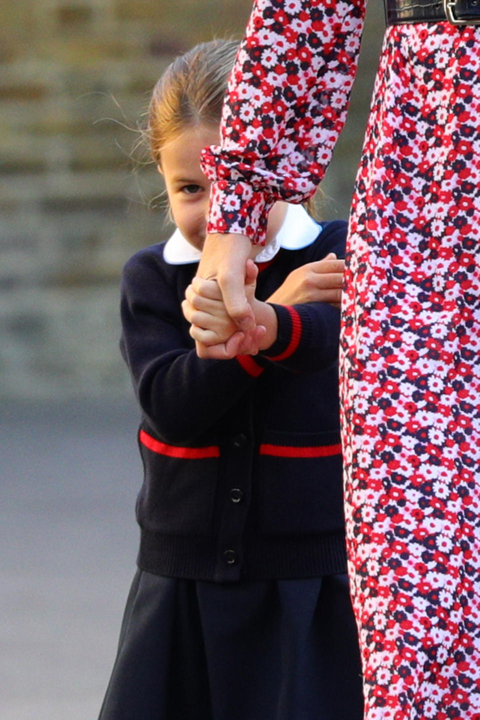 <p>Charlotte hid behind her mother on the way to her first day of school at Thomas's Battersea. (PA Images)</p> 