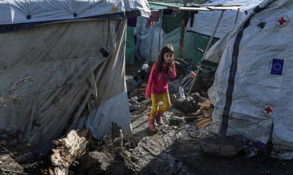 A girl walks on a muddy path at a makeshift camp next to the Moria refugee camp on Lesbos, Greece, on 29 November.