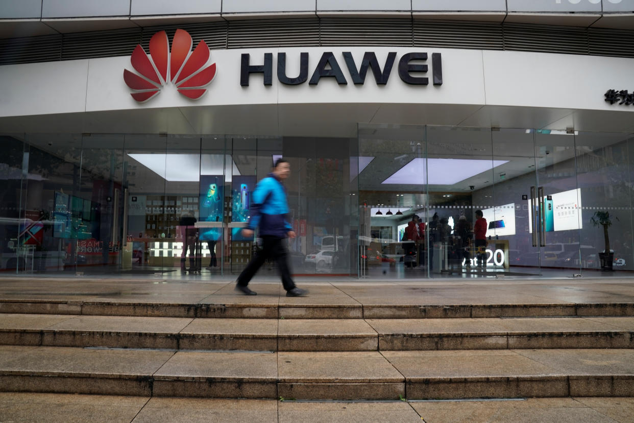 A man walks by a Huawei logo at a shopping mall in Shanghai, China December 6, 2018. REUTERS/Aly Song