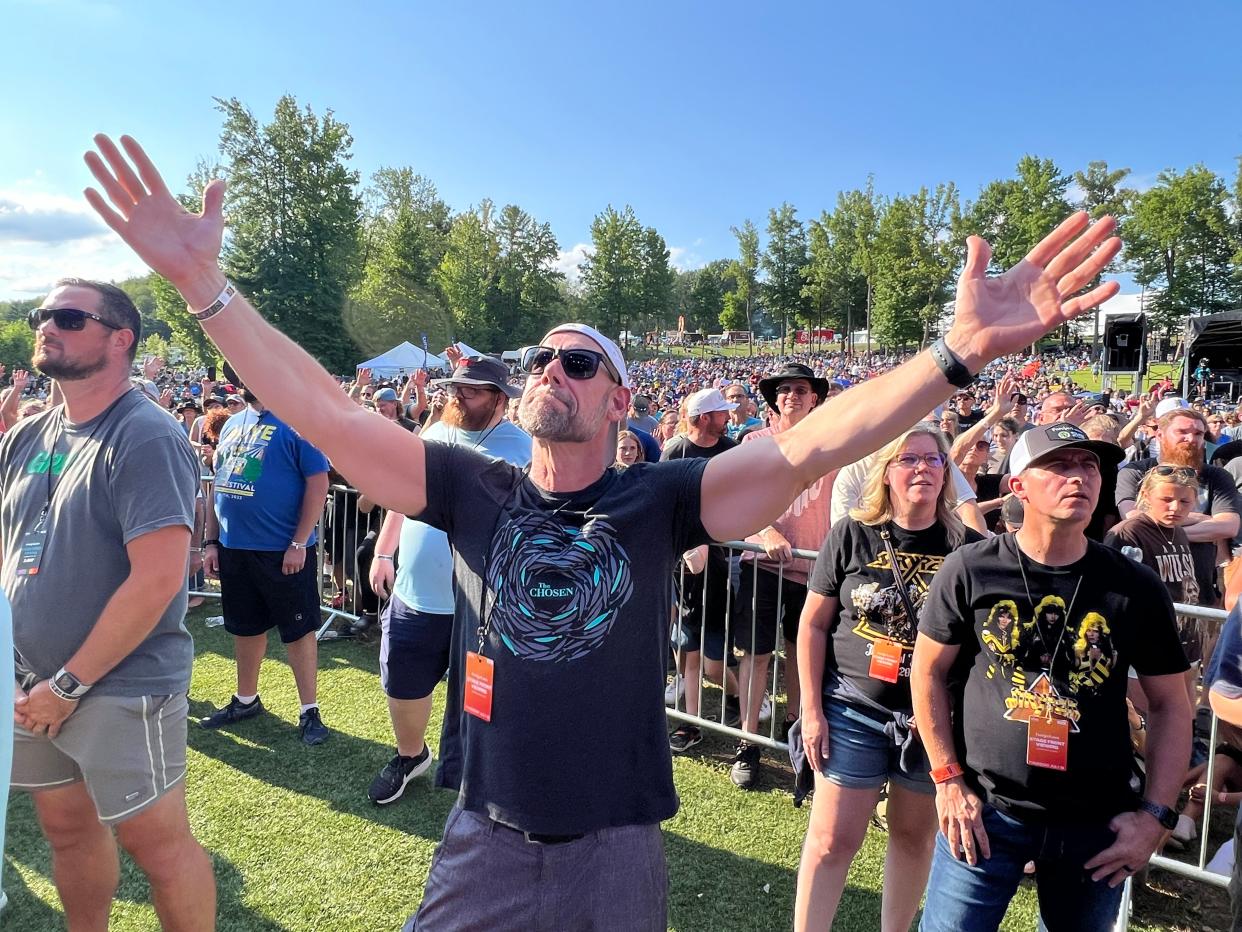 A fan enjoys the Stryper concert Thursday afternoon on the first day of the Alive Music Festival at Atwood Lake Park in the Mineral City area. The festival continues through Saturday.