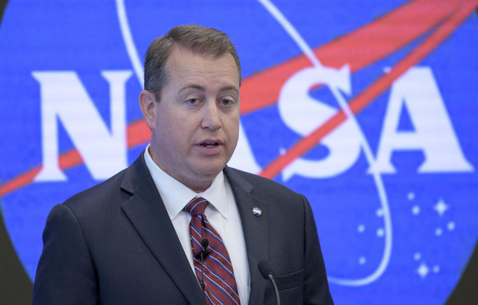 In this image provided by NASA, NASA Chief Financial Officer Jeff DeWit speaks during a news conference Friday, June 7, 2019, in New York. NASA announced Friday that it will open the International Space Station to private astronauts, with the first visit as early as next year. The round-trip ticket will cost an estimated $58 million. And accommodations aboard the orbiting outpost will run about $35,000 per night, for trips of up to 30 days long. (Bill Ingalls/NASA via AP