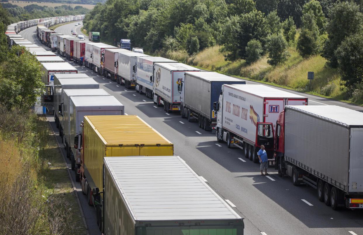 Drivers wait next to their parked lorries on the M20 motorway, which leads from London to the Channel Tunnel terminal at Ashford and the Ferry Terminal at Dover, as part of Operation Stack in  southern England, Britain July 31, 2015. Prime Minister David Cameron drew up plans to help France tackle a spike in attempts by migrants to enter Britain illegally via the Channel Tunnel, but warned there was no quick fix. Cameron is under pressure to deter the migrants, many of whom have travelled from Africa and the Middle East, after disruption to cross-Channel passenger and freight traffic. REUTERS/Neil Hall