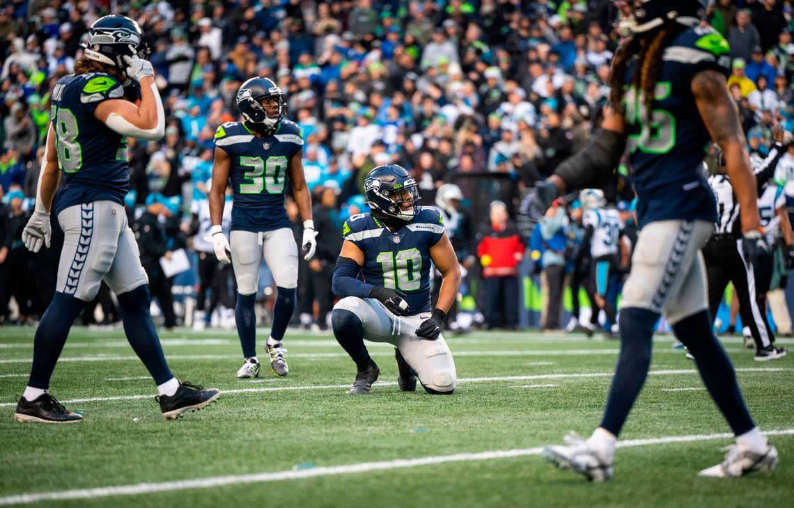 Seattle Seahawks linebacker Uchenna Nwosu (10) kneels after watching the Carolina Panthers score a touchdown in the third quarter of an NFL game at Lumen Field in Seattle Wash., on Dec. 11, 2022. The Seahawks lost to the Panthers 24-30.