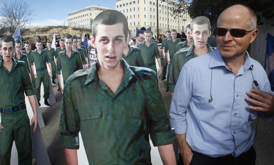 File photo of Noam Shalit standing near cardboard cut-outs of his son Gilad Shalit during protest in Jerusalem