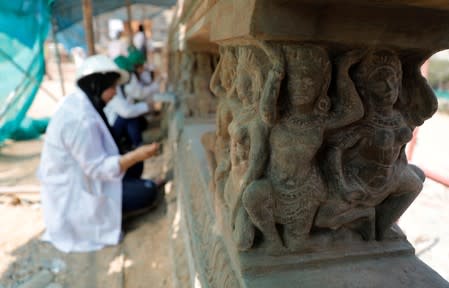 Egyptian archaeologists work on restoring relief sculptures at the Baron Empain Palace, in the Cairo's suburb Heliopolis