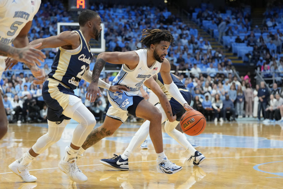 Dec 29, 2023; Chapel Hill, North Carolina, USA; North Carolina Tar Heels guard RJ Davis (4) dribbles as Charleston Southern Buccaneers guard RJ Johnson (22) defends in the first half at Dean E. Smith Center. Mandatory Credit: Bob Donnan-USA TODAY Sports