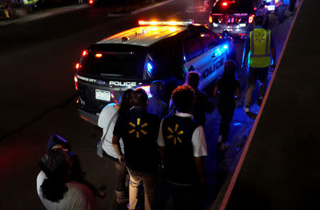 Walmart employees and shoppers leave the scene of a shooting at a Walmart in Thornton, Colorado November 1, 2017. REUTERS/Rick Wilking