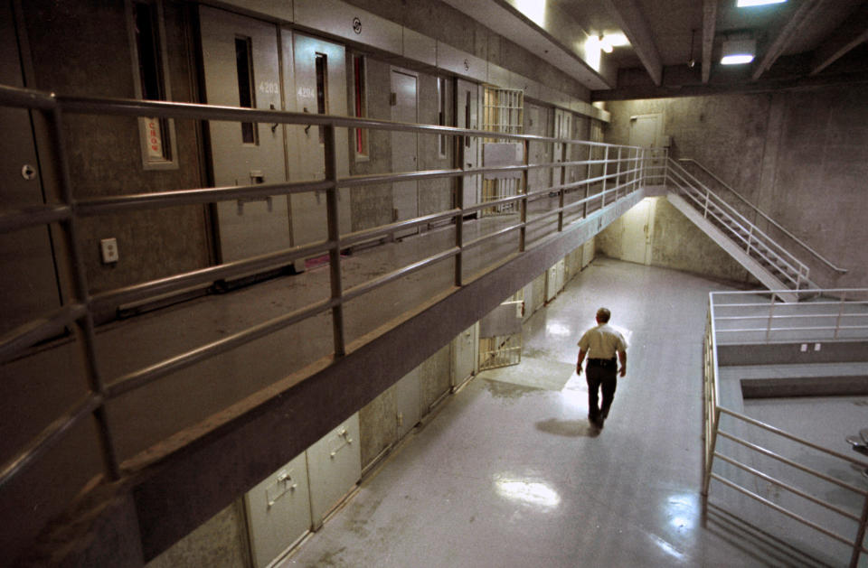 FILE — In this Oct. 28, 1999, file photo a correctional officer walks through a housing unit during a lockdown at California State Prison, Sacramento, in Folsom, Calif. Correctional Sgt. Kevin Steele, 56, killed himself after reporting corruption and harassment at the prison to authorities and cooperating with attorneys suing the state according to the Sacramento Bee, Wednesday, Oct. 6, 2021. (AP Photo/Rich Pedroncelli, File)