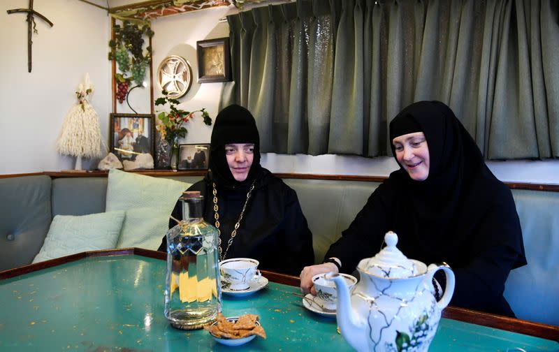 Two nuns sits in the livingroom of a mobile Georgian Orthodox monastery in Vlissingen