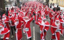 MICHENDORF, GERMANY - DECEMBER 09: Participants dressed as Santa Claus take off in the 4th annual Michendorf Santa Run (Michendorfer Nikolauslauf) on December 9, 2012 in Michendorf, Germany. Over 800 people took part in this year's races that included children's and adults' races. (Photo by Sean Gallup/Getty Images)