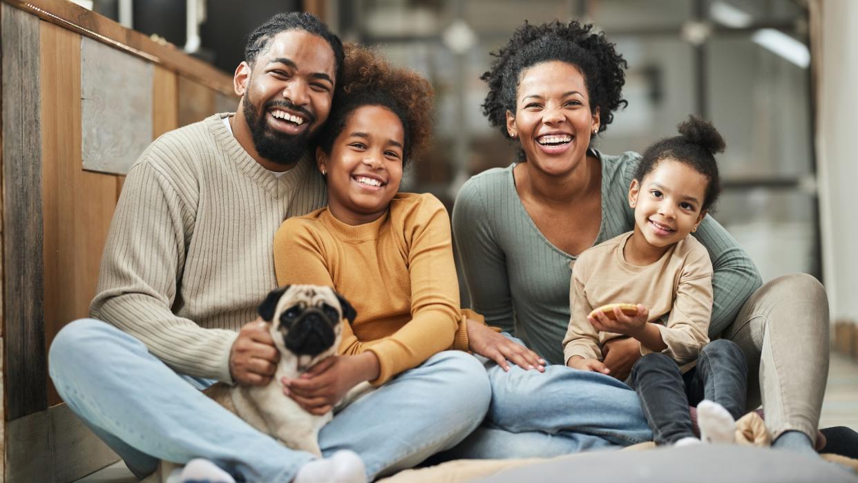  Happy family at home with their dog 