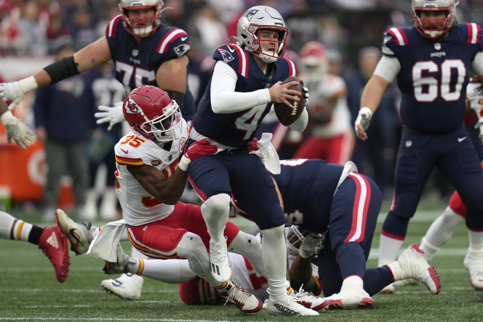 New England Patriots quarterback Bailey Zappe (4) is stopped by Kansas City Chiefs cornerback Jaylen Watson (35) during the second half of an NFL football game, Sunday, Dec. 17, 2023, in Foxborough, Mass. (AP Photo/Charles Krupa)