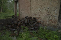 Russian ordinance on the ground of a concert hall damaged by strikes, in Yahidne village, northern Chernihiv region, Ukraine, Wednesday, June 29, 2022. A few months after Russian troops retreated from Yahidne, the village has gradually returned to life. People are repairing their homes, and a strong wind occasionally picks up the bitter smell of ashes. (AP Photo/Nariman El-Mofty)