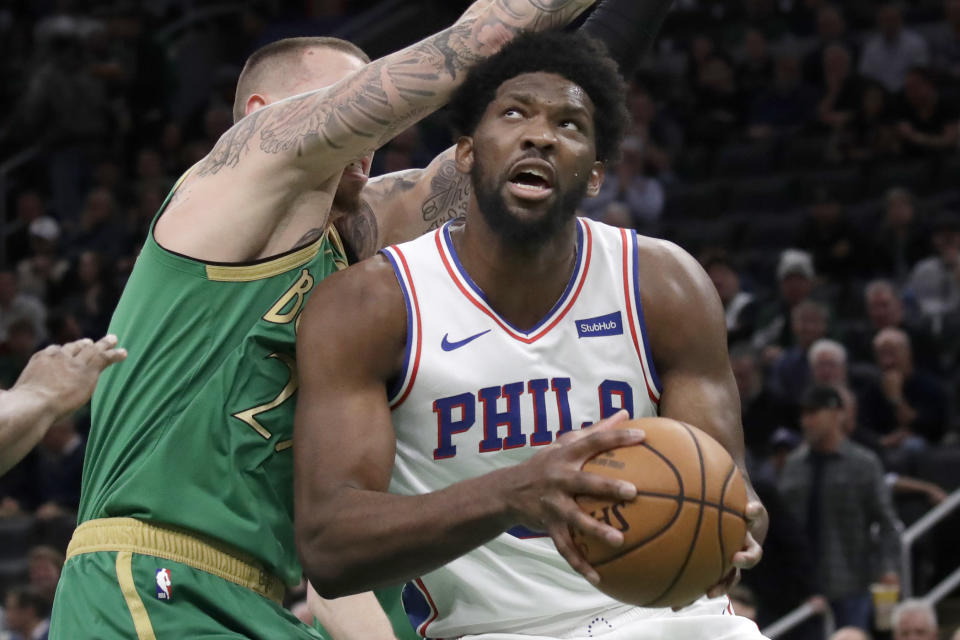 Philadelphia 76ers center Joel Embiid looks for room to shoot against Boston Celtics forward Daniel Theis, left, in the first quarter of an NBA basketball game, Thursday, Dec. 12, 2019, in Boston. (AP Photo/Elise Amendola)