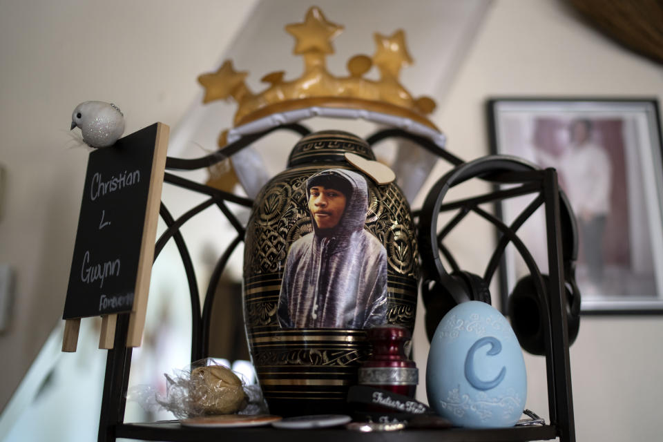 An urn containing the remains of Christian Gwynn sits on a shelf in his family's home in Louisville, Ky., Monday, Aug. 28, 2023. Christian, 19, was killed in a drive-by shooting four blocks from home in December 2019. Just two years later, his sister, Victoria, then also 19, was shot and injured at a park on Louisville’s eastside. The 17-year-old friend she was there to meet was killed. (AP Photo/David Goldman)