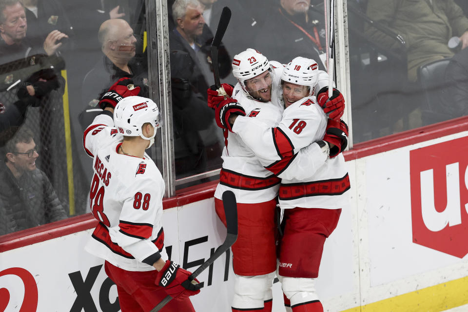 Carolina Hurricanes right wing Stefan Noesen (23) celebrates with center Jack Drury (18) after Noesen scored a goal against the Minnesota Wild during the third period of an NHL hockey game Tuesday, Feb. 27, 2024, in St. Paul, Minn. (AP Photo/Stacy Bengs)