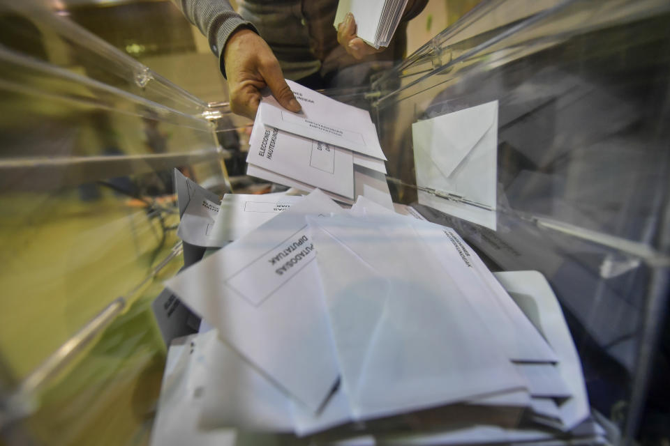 Election official count votes at a polling station for Spain's general election, in Pamplona, northern Spain, Sunday, Nov. 10, 2019. As Spaniards voted Sunday in the country’s fourth election in as many years, a leading leftist party pledged to help the incumbent Socialists in hopes of staving off a possible right-wing coalition government that could include a far-right party. (AP Photo/Alvaro Barrientos)