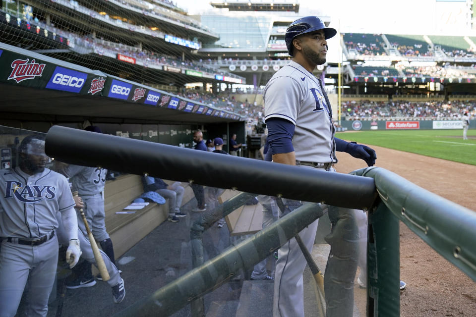 Tampa Bay Rays' Nelson Cruz waits on the visiting team dugout steps to bat in the first inning of a baseball game against the Minnesota Twins, his former team, Friday, Aug. 13, 2021, in Minneapolis. (AP Photo/Jim Mone)