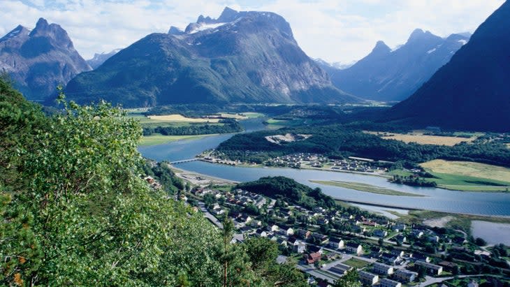 <span class="article__caption">Looking out over Andalsnes (while discussing your empire) from Mount Nesaksla in the Western Fjords region, Norway</span> (Photo: Craig Pershouse/Getty)