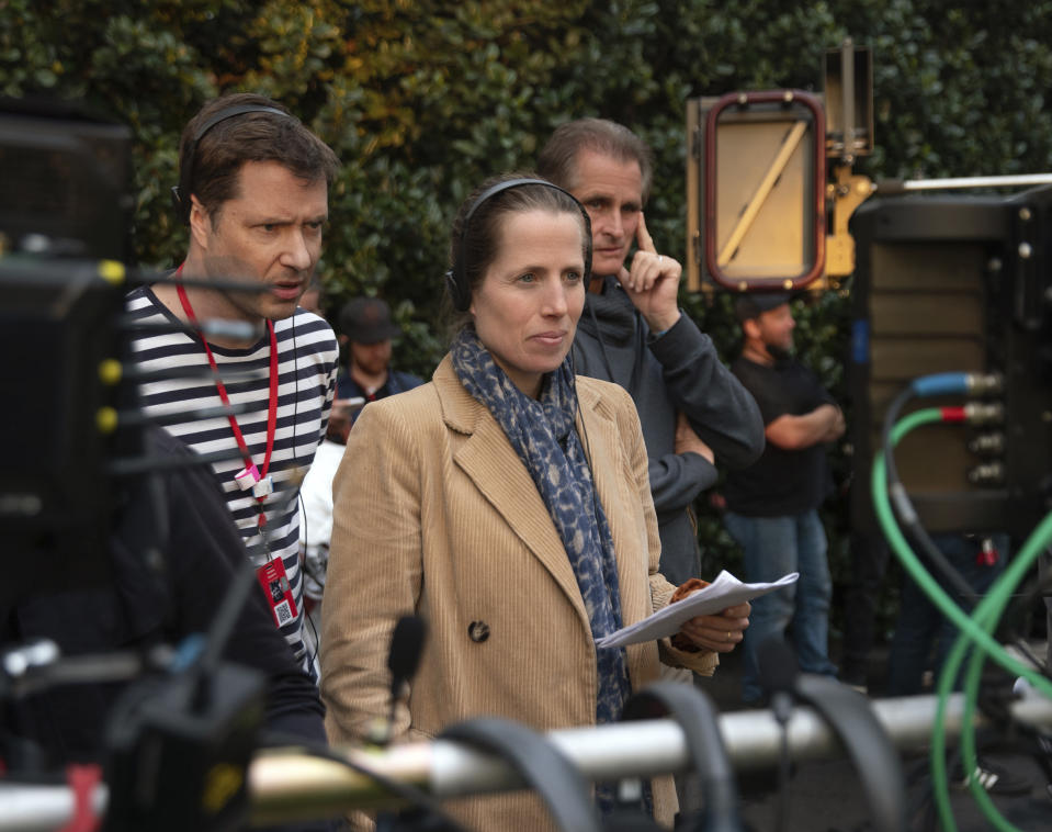 This image released by Apple shows co-directors Kristin Gore, center, and her husband Damian Kulash, left, on the set of "The Beanie Bubble." (Apple via AP)