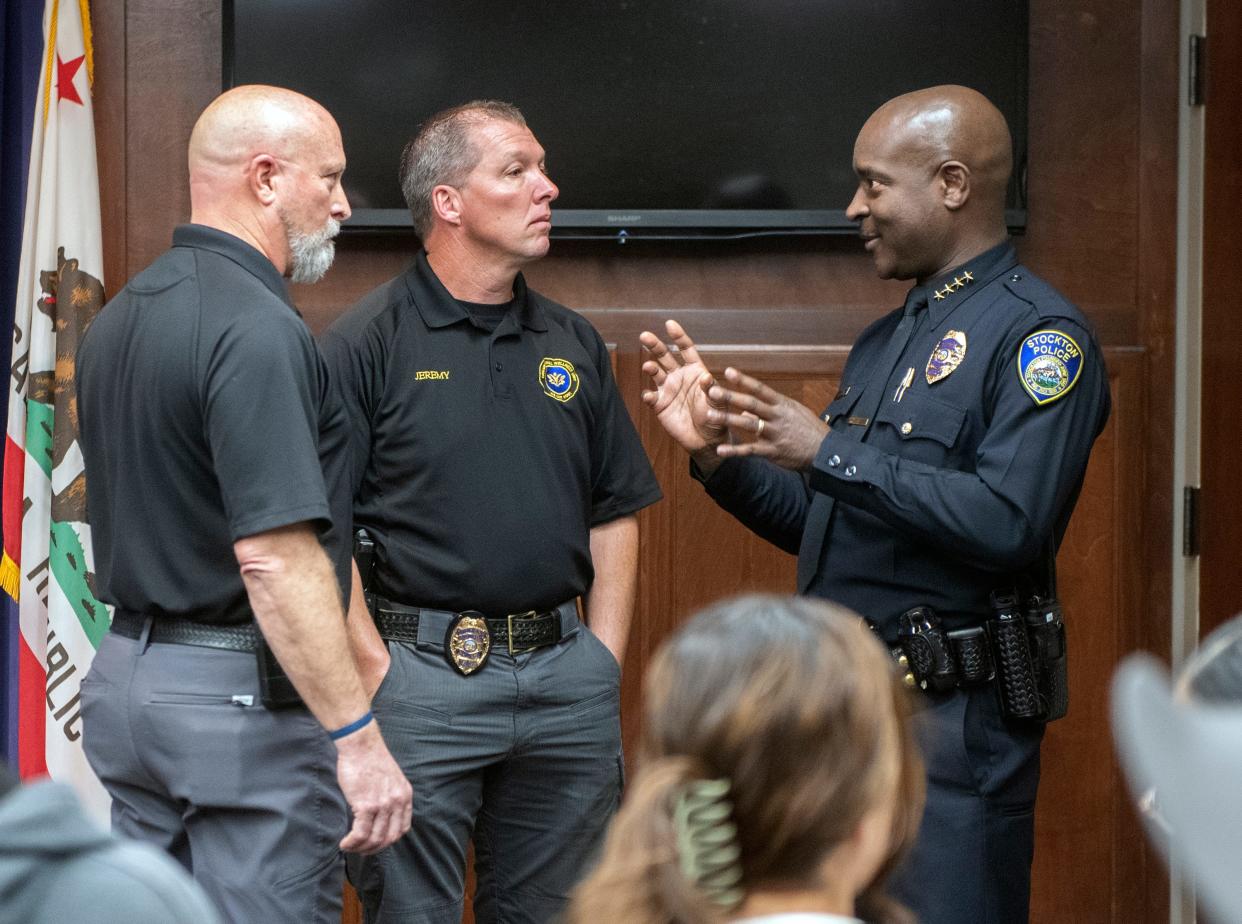Stockton Police Chief Stanley McFadden, right, talks with police chaplain Jesse Kenyon, left. McFadden is undertaking a reorganization of the department to put more officers on patrol.