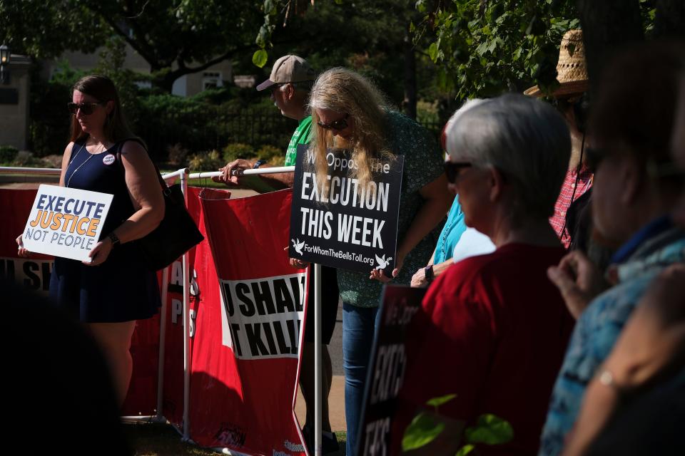 Death penalty opponents gather near the governor's mansion Thursday to protest the execution of James Coddington.